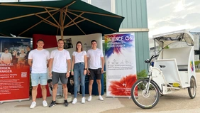 4 students standing in front of a booth