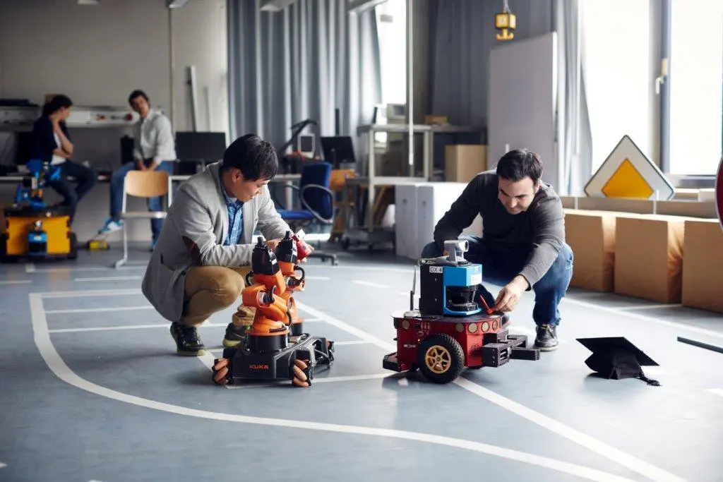 Two graduates testing robots at the lab for robotics.