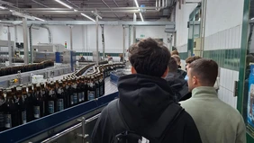 People next to the Herrenbräu brewery bottling plant. 