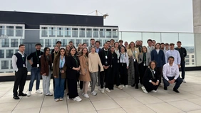 A group photo of the excursion group on the roof of the company building.