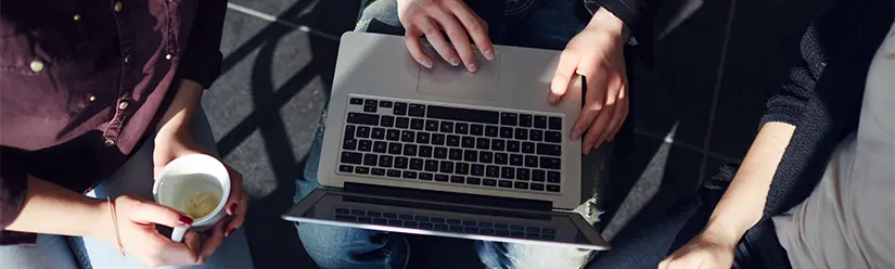 View from above on a laptop, 3 people are standing around